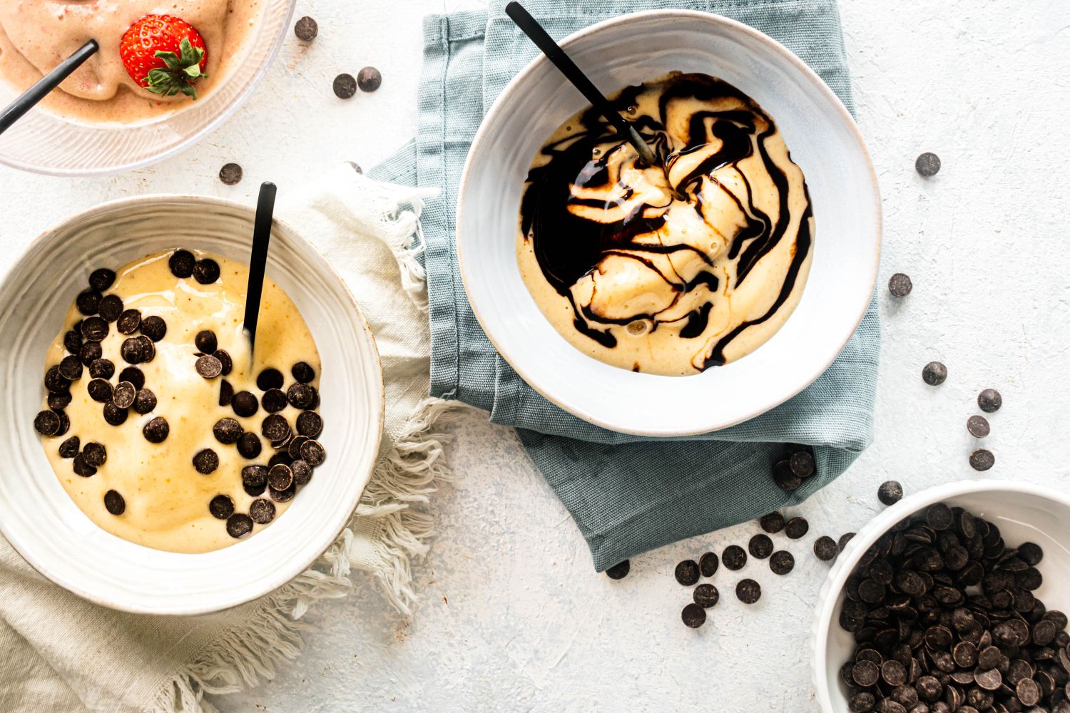 Banana Nice Cream (5 Flavor Ideas!) Banana nice cream with creamy frozen bananas topped with chocolate chips, chocolate syrup, and fresh strawberries.