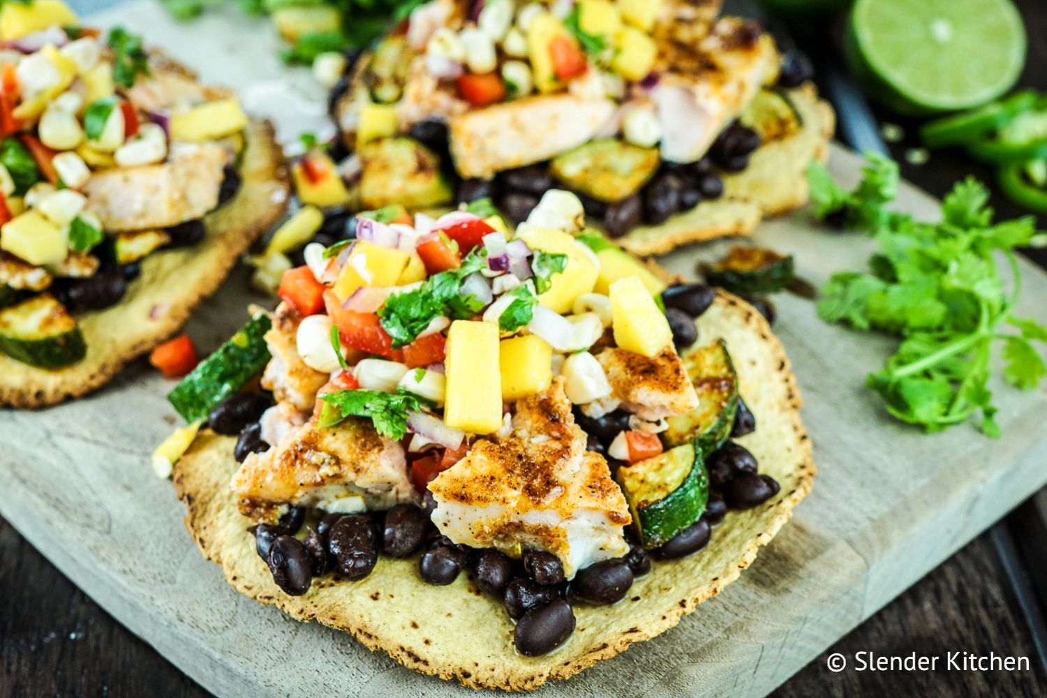 Blackened Salmon Tostadas Salmon tostadas with blackened salmon, zucchini, veggies, and cheese on a crispy tortilla.