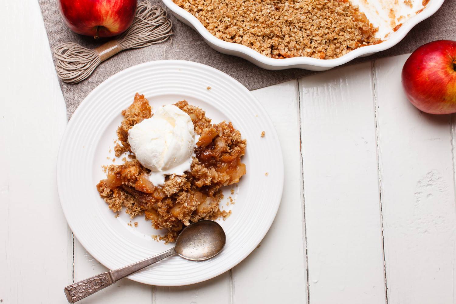 Breakfast Apple Crisp Breakfast apple crisp served on a plate with tender baked apples, an oat crumble, and yogurt.