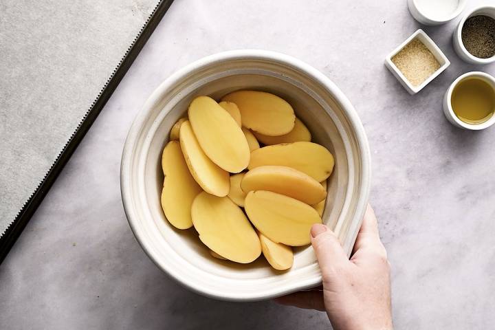 Roasted Fingerling Potatoes Fingerling potatoes cut in half in a white bowl.