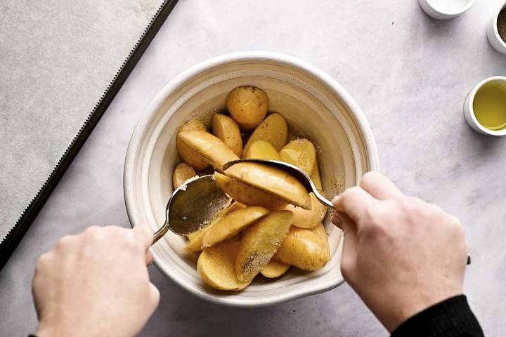 Roasted Fingerling Potatoes Bowl with fingerling potatoes, olive oil, salt, pepper, and spices.