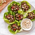 Asian Ground Beef Lettuce Wraps Asian ground beef lettuce wraps served on a plate with beef, mushrooms, peppers, and cashews wrapped in butter lettuce.