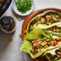 Slow Cooker Chicken Lettuce Wraps Slow cooker chicken lettuce wraps on a plate with lettuce leaves stuffed with chicken, mushrooms, peppers, and cilantro.