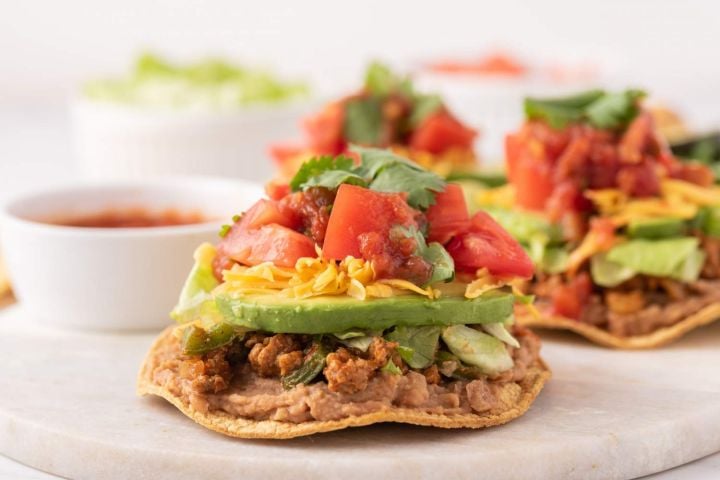 50 Easy & Healthy Ground Turkey Recipes Ground turkey tostadas with beans, ground turkey, avocado, tomatoes, cheese, and cilantro.