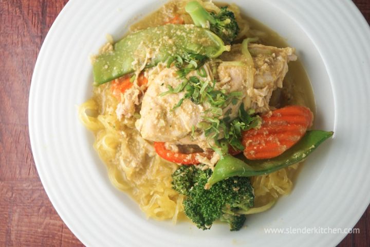 Slow Cooker Coconut Curry Chicken Slow cooker chicken curry with vegetables in a coconut milk broth in a bowl.