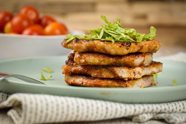 Sweet and Spicy Pork Sweet and spicy pork chops piled on a brown sugar spice rub on a plate with parsley.