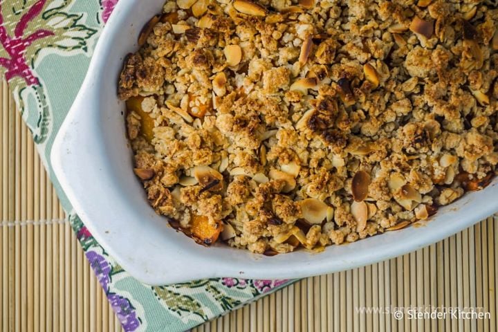Apricot Crumble Apricot crumble with a crispy baked topping in a ceramic dish.