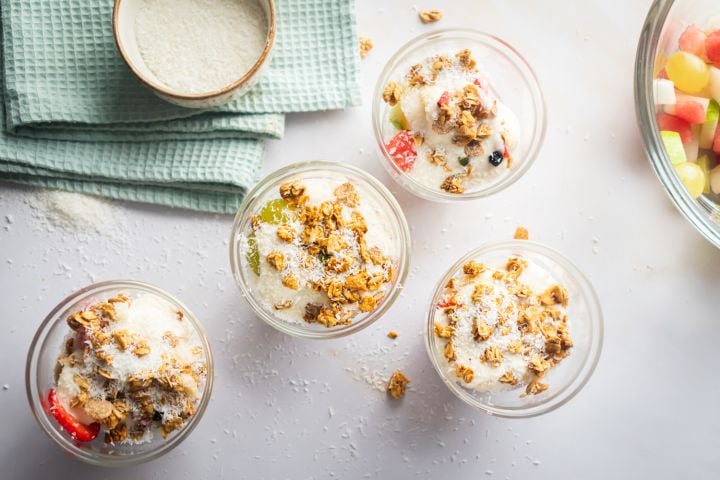 Bionico (Mexican Fruit Salad) Bionico fruit salad with strawberries, watermelon, grapes, and apples in a glass jar with a sweet yogurt sauce.