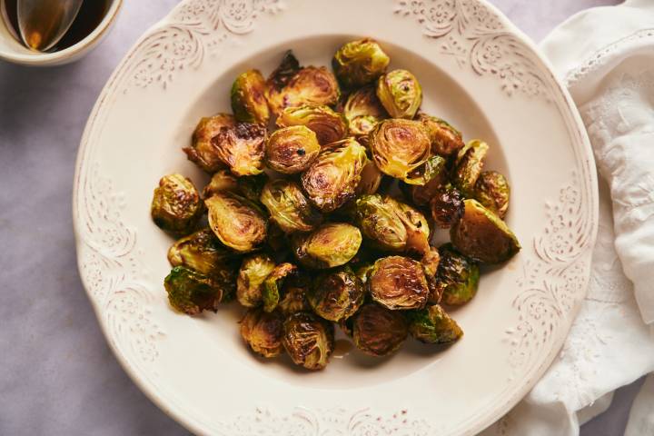 Caramelized Brussels Sprouts Caramelized Brussels sprouts with browned, crispy edges in a bowl with honey balsamic galze.