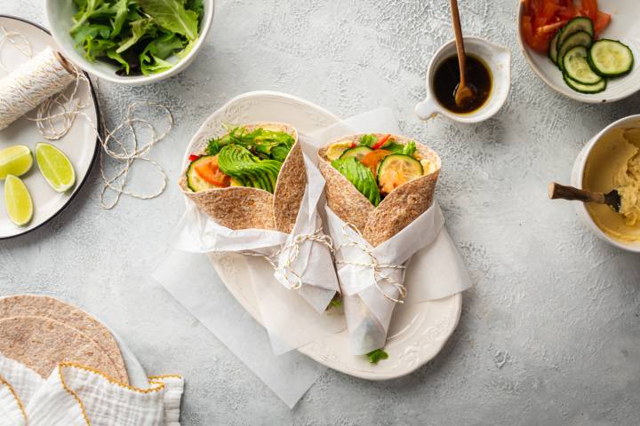 Hummus Vegetable Wraps Hummus wrap with mixed greens, tomatoes, cucumbers, avocado, carrots, and bell peppers in whole wheat tortillas.