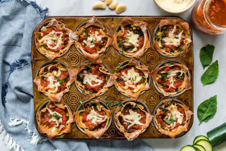 Lasagna Cupcakes Lasagna cupcakes with ricotta cheese, vegetables, and mozzarella cheese baked in a muffin tin with marinara sauce.