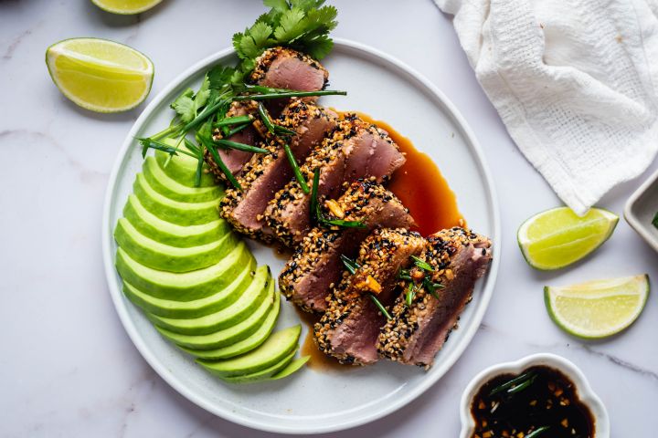 Sesame Crusted Tuna Sesame crusted tuna sliced and cooked rare served with soy dipping sauce and avocado.