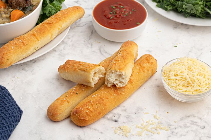 Two Ingredient Dough Breadsticks Two ingredient dough breadsticks made with Greek yogurt and self rising flour on a plate with marinara sauce on the side.