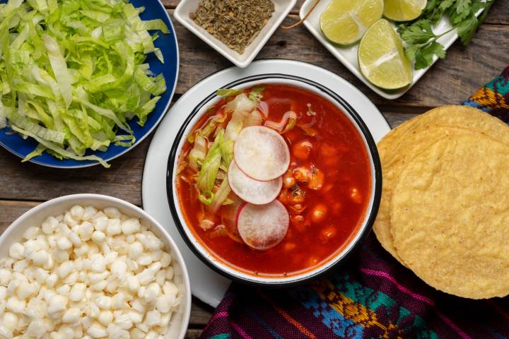 Vegetarian Pozole Vegetarian pozole with hominy, beans, radishes, avocado, and a rich dried red chile broth.