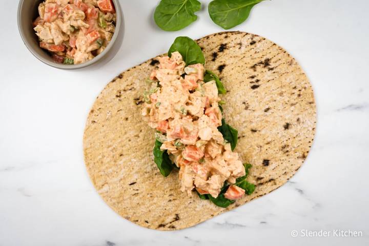 Buffalo ranch chicken salad in a wrap with spinach.