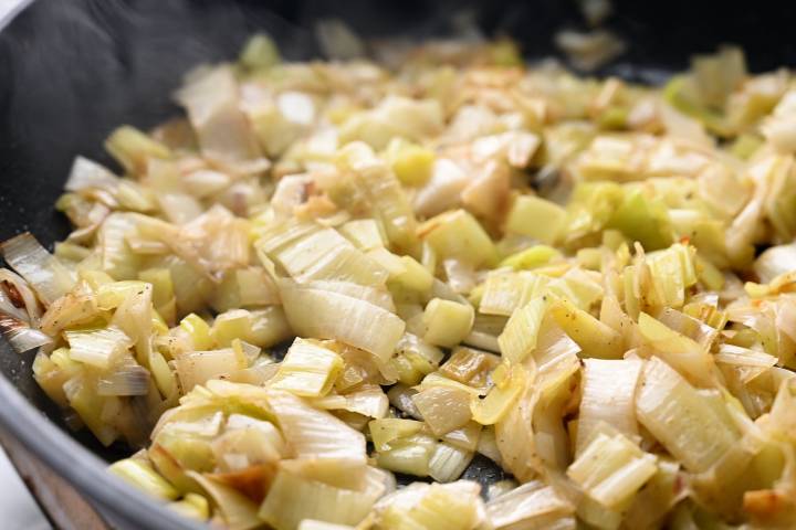Leeks sautéing in the pan with butter and olive oil.