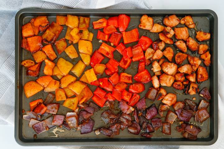 Roasted honey sriracha chicken and vegetables on a sheet pan.