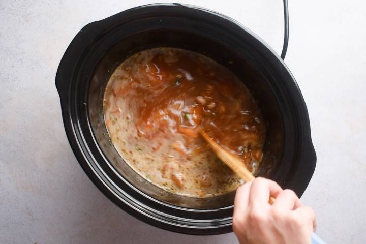 Pinto beans, beer, tomatoes, jalapenos, and onions in a slow cooker.