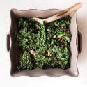 Sauteed kale with garlic, red wine vinegar, salt, and pepper in a ceramic dish.
