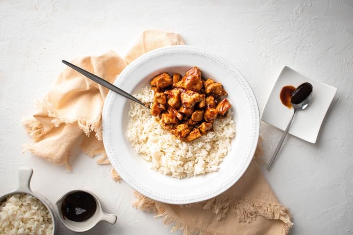 Spicy skillet hoisin chicken with chicken breast covered in hoisin sauce and served with rice.