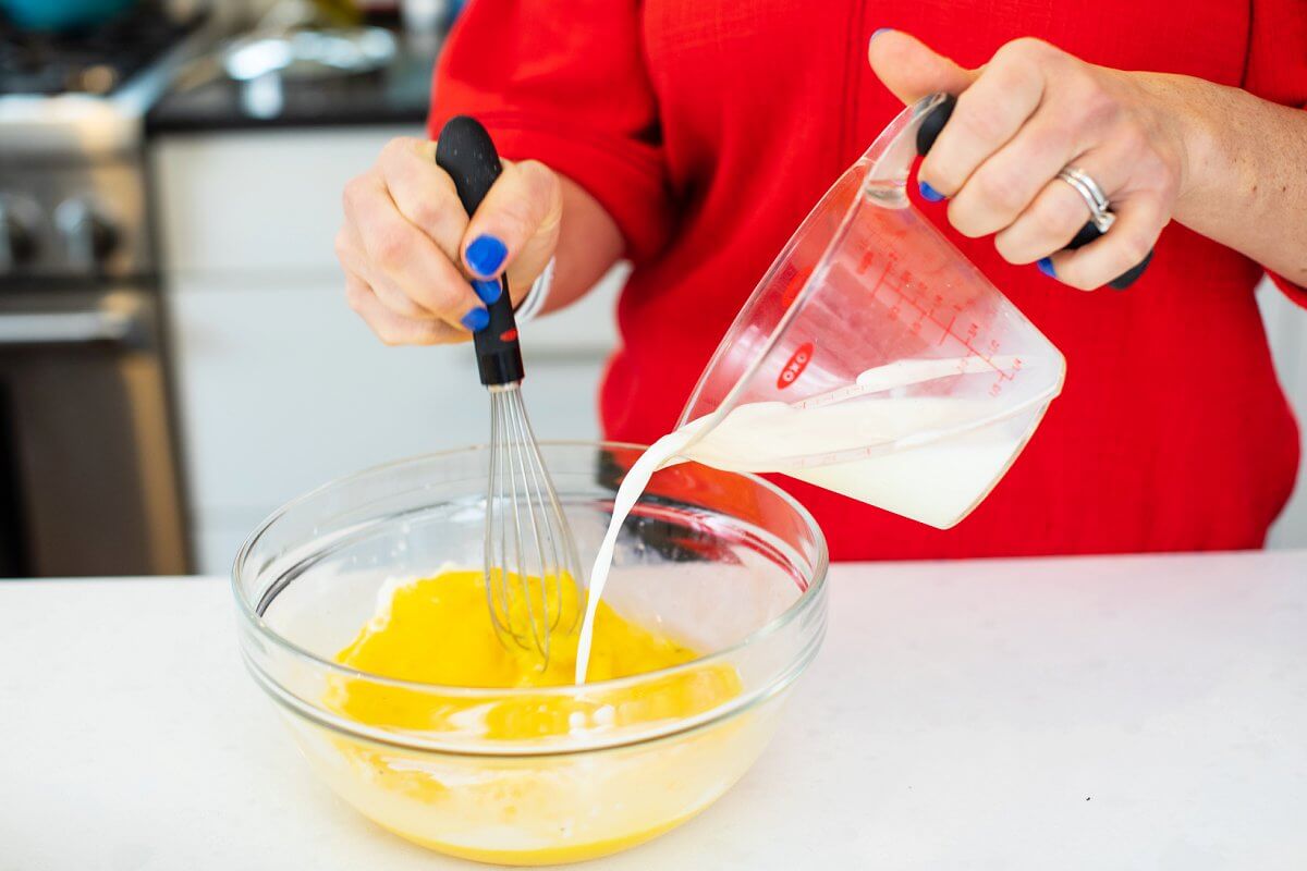 Whisking eggs with milk.