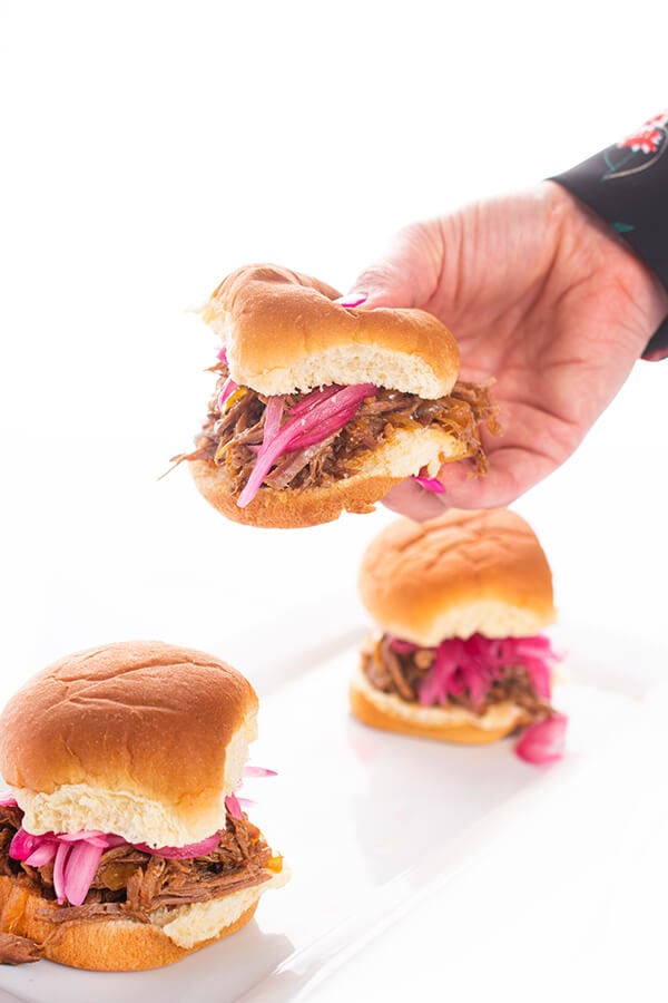 beef sliders with pickled onions on a bun
