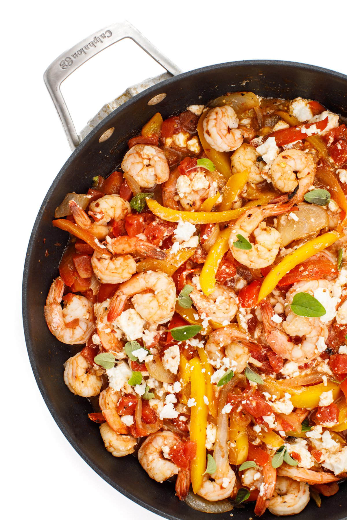 Mediterranean sautéed shrimp in a large black skillet.