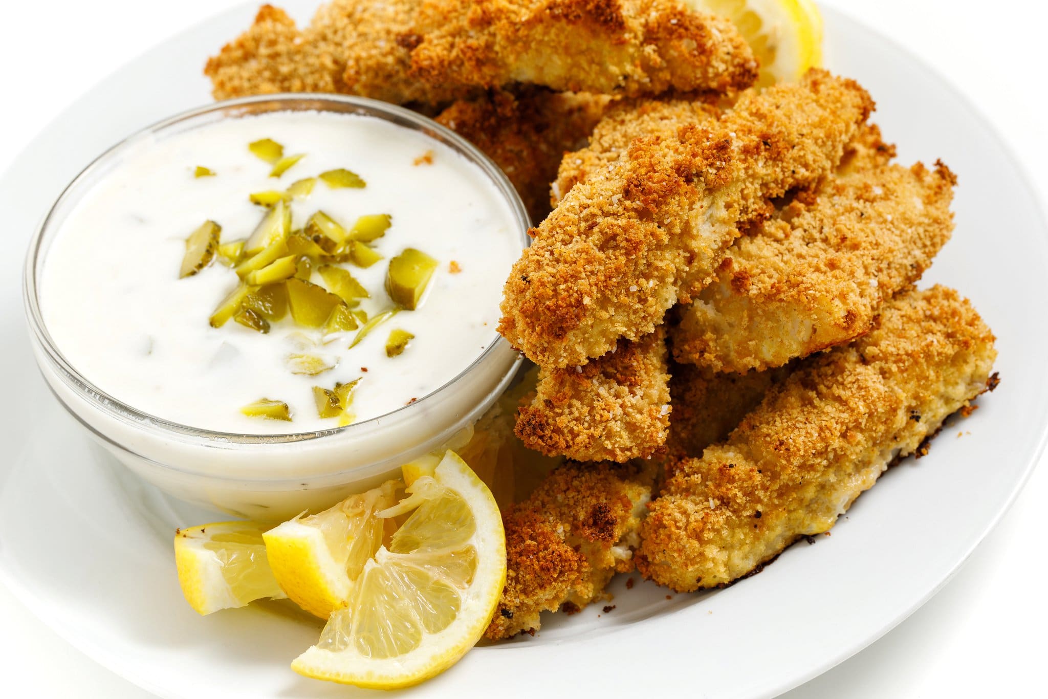 Baked fish sticks with tartar sauce.