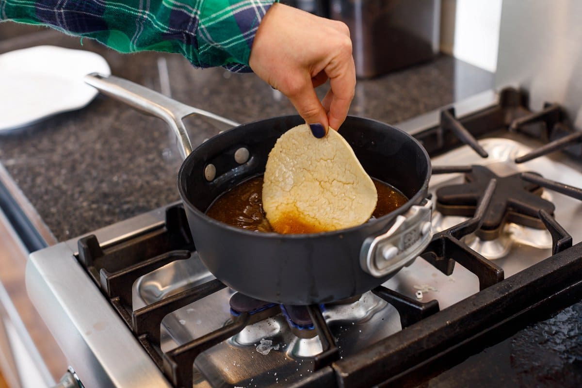 Liz dipping tortillas in broth