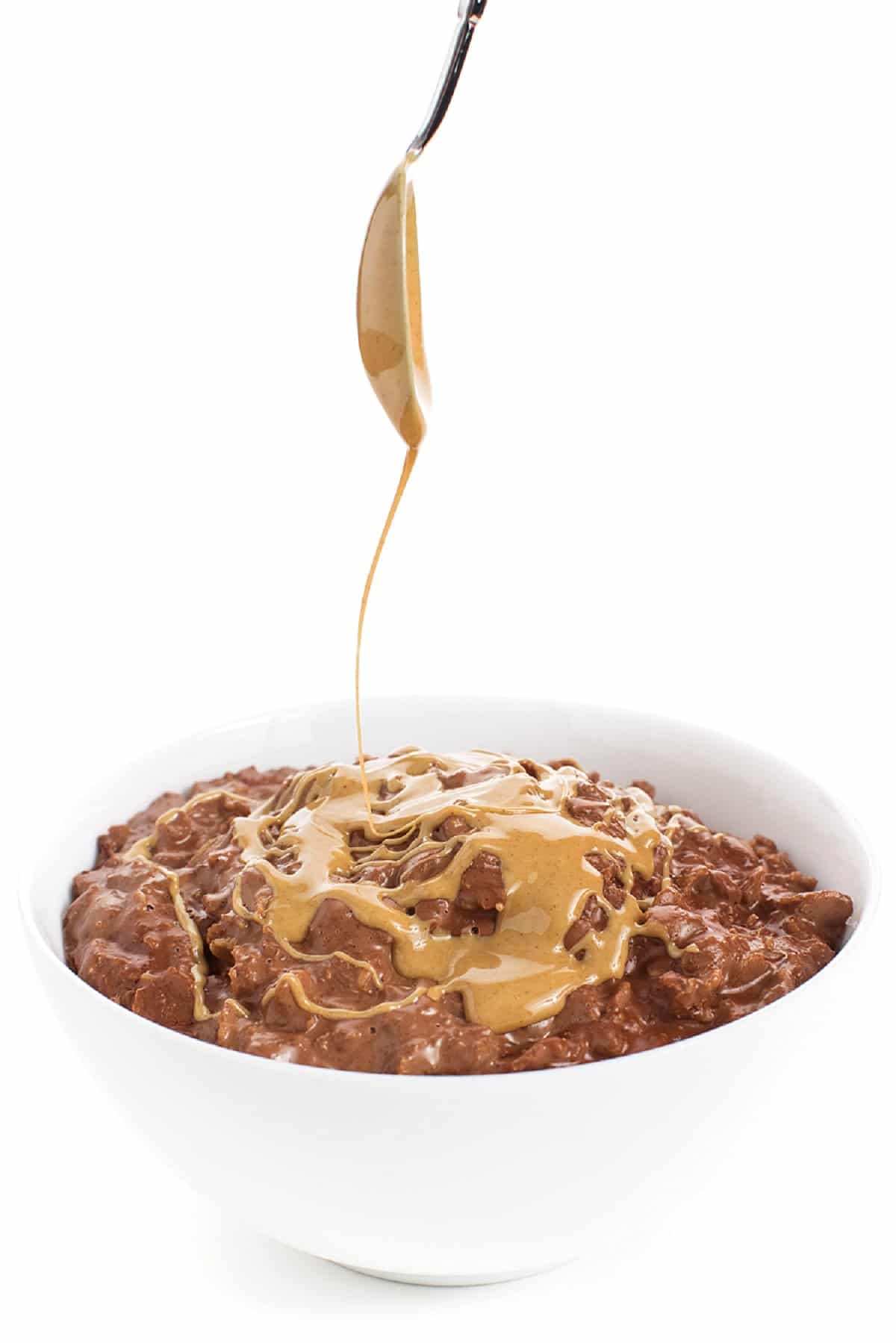 Drizzling peanut butter over the top of chocolate peanut butter oatmeal.