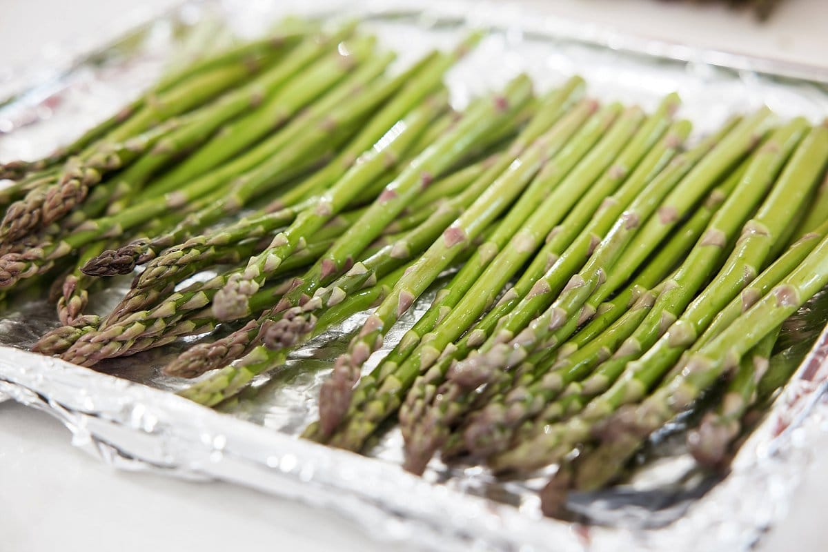 broiled asparagus on a baking sheet