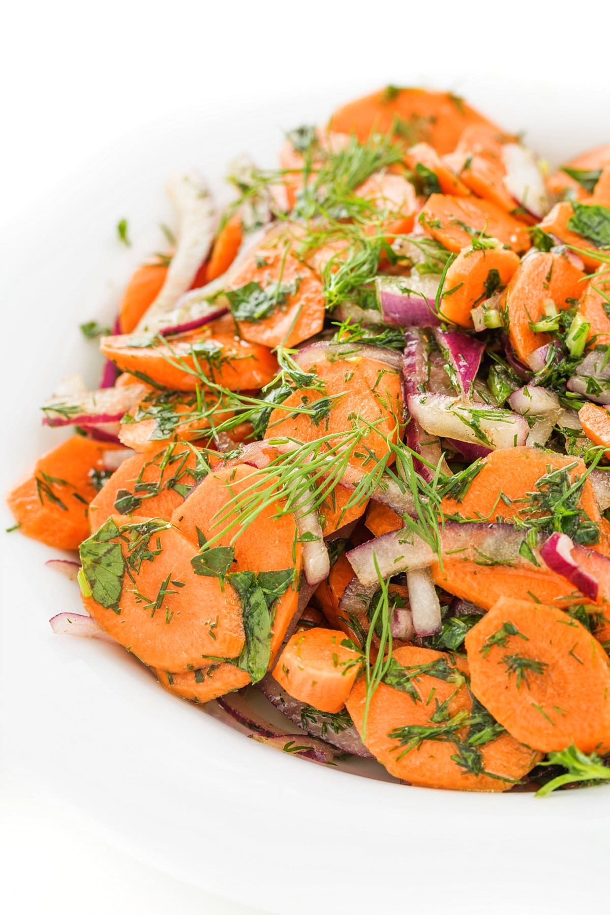 Carrot salad with honey vinaigrette and garnished with fresh dill.