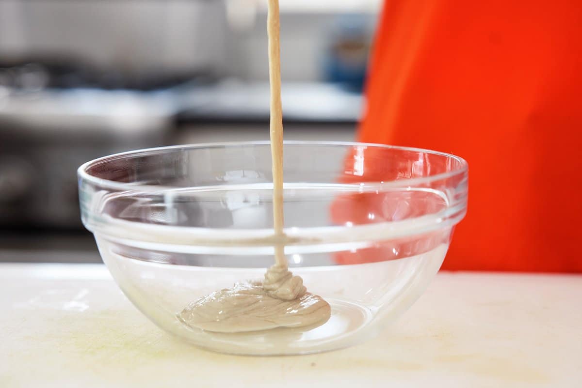 pouring tahini into a bowl