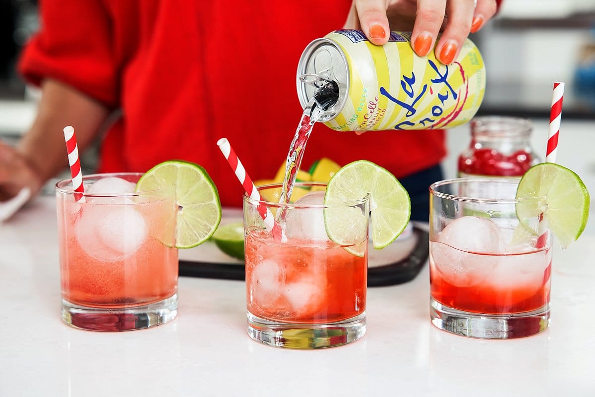 adding soda to glasses