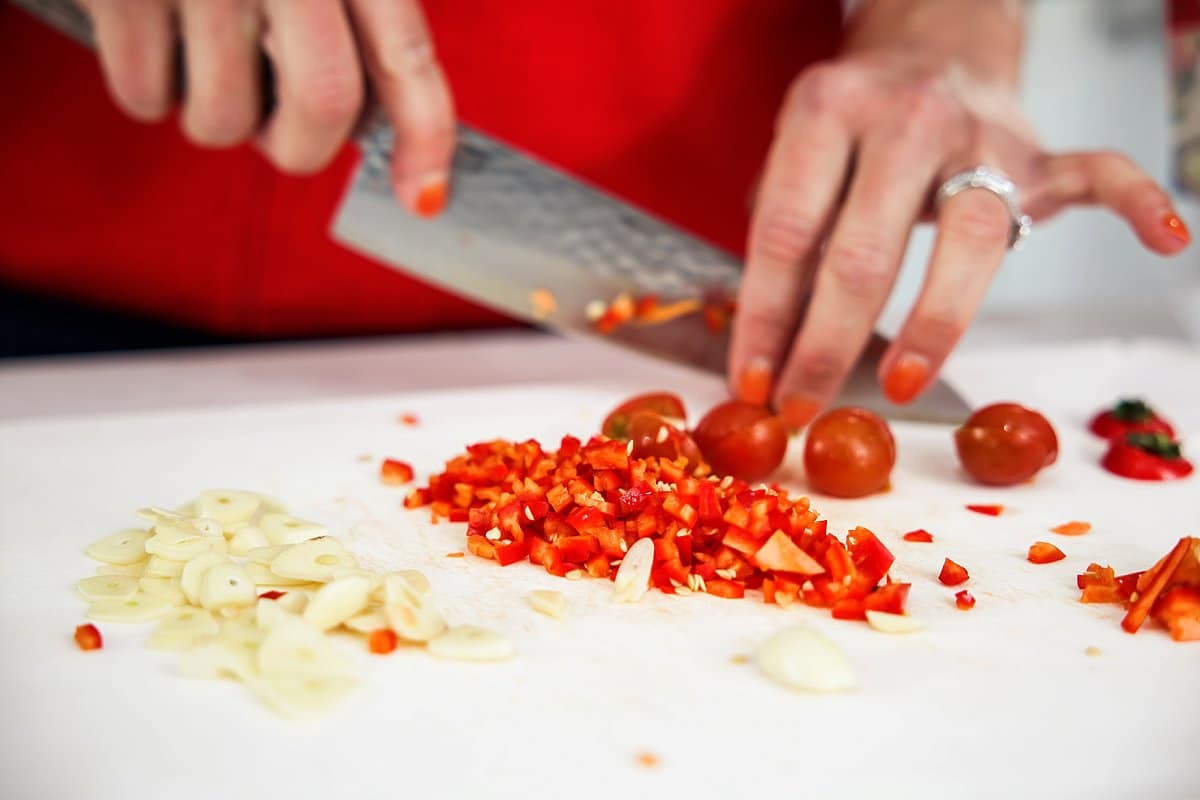 cutting tomatoes and chilis for spicy pasta