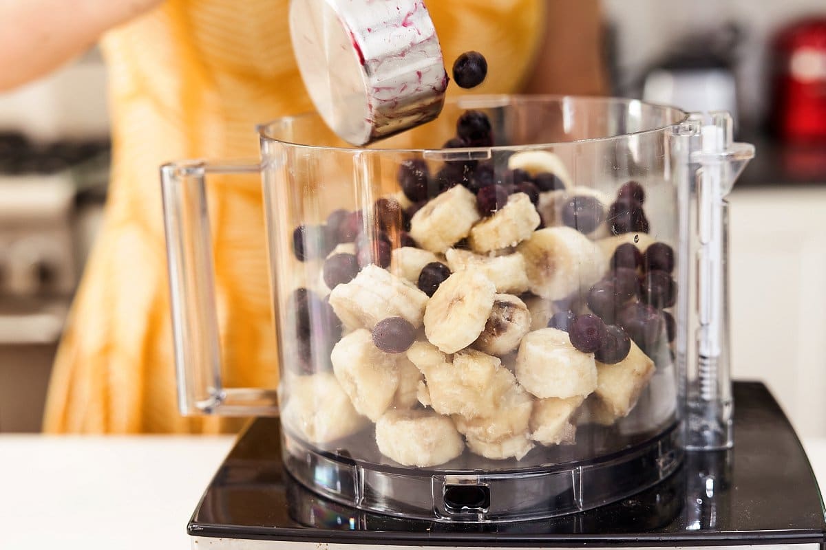 Adding blueberries to vegan blueberry nice cream