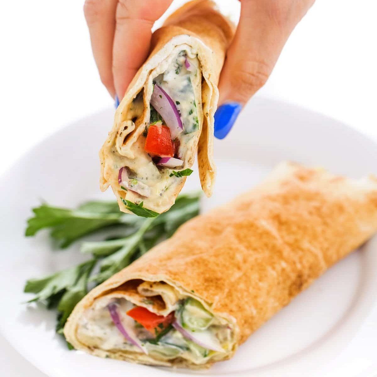 Person holding Lebanese salad wraps