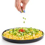 corn skillet having garnish sprinkled onto