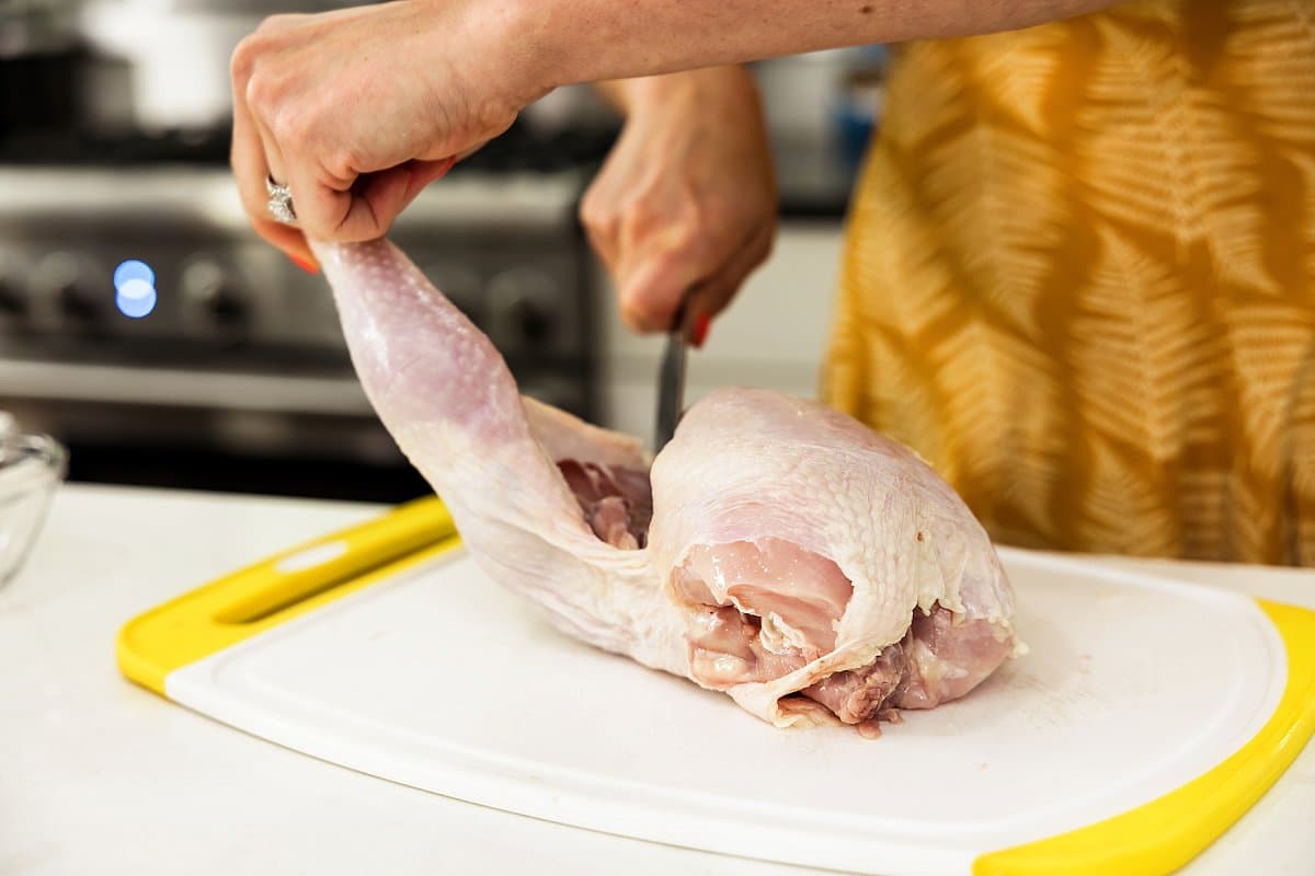 cutting raw chicken