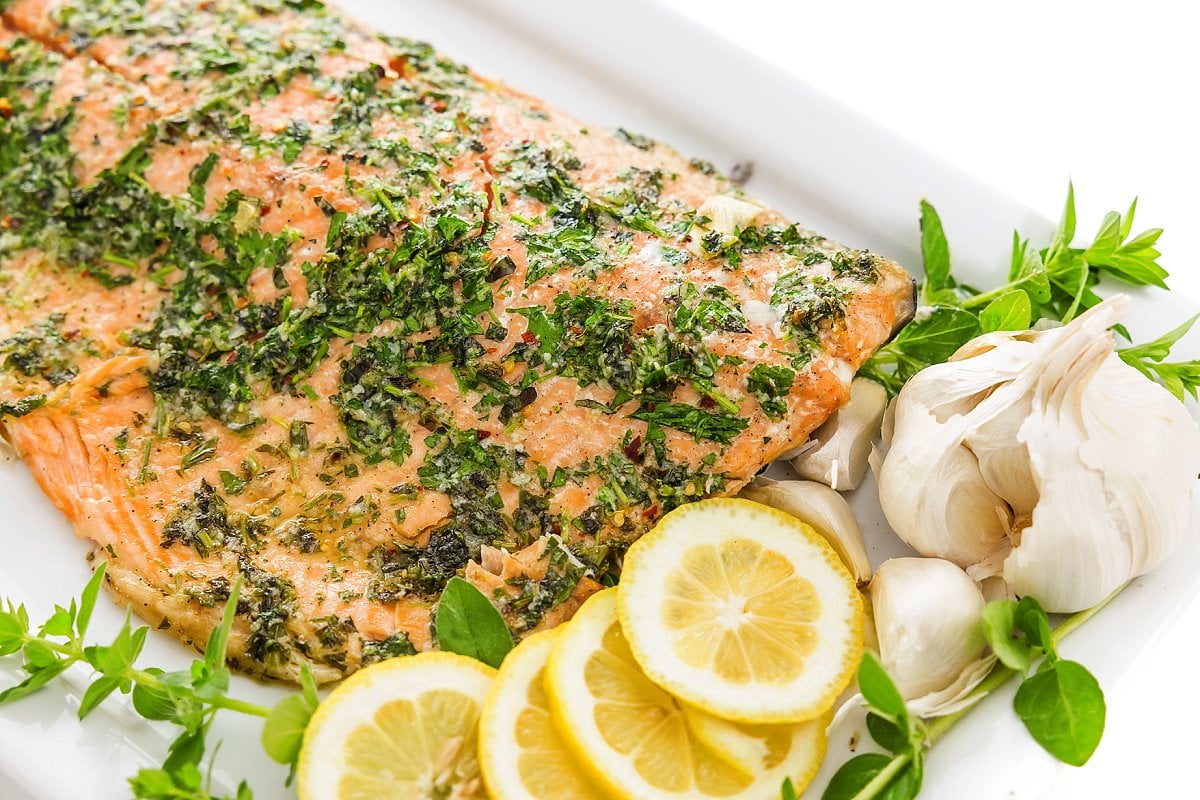 plate of baked salmon with fresh herbs