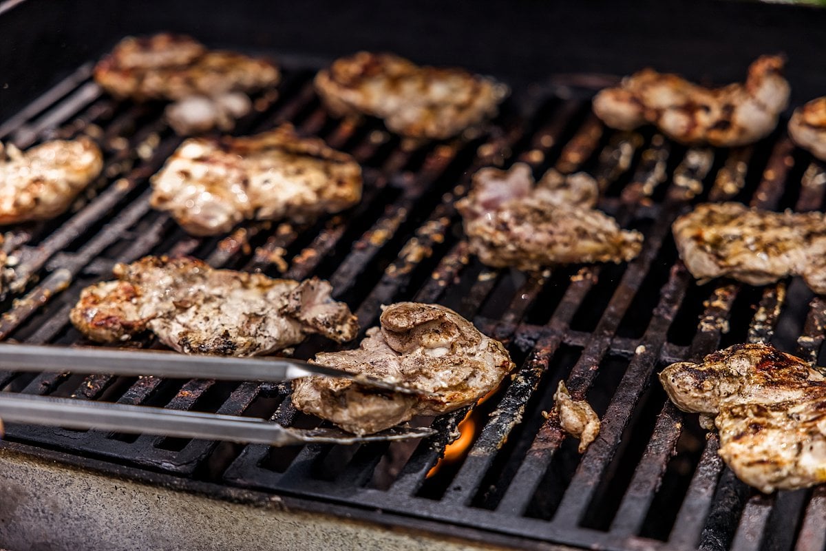 chicken sizzling on a grill