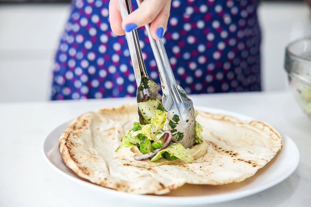 topping syrian salad on lebanese salad wraps