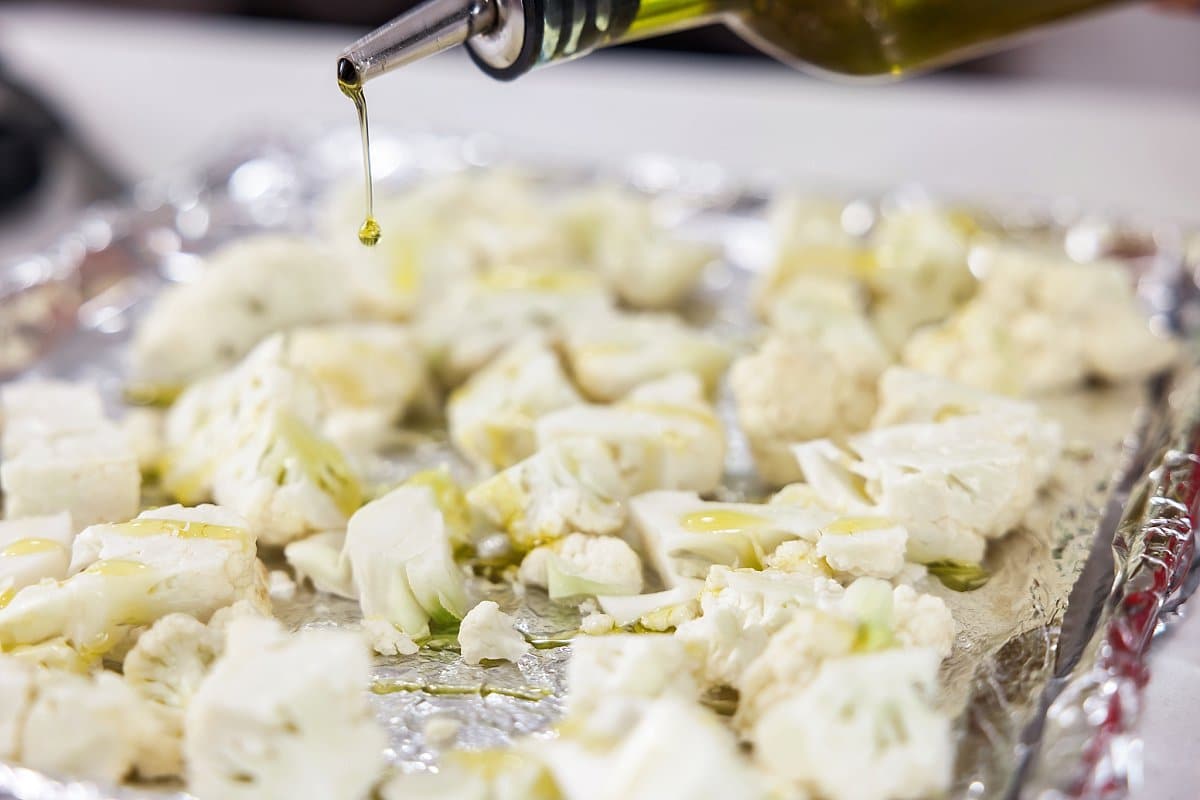 cauliflower having olive oil drizzled onto it