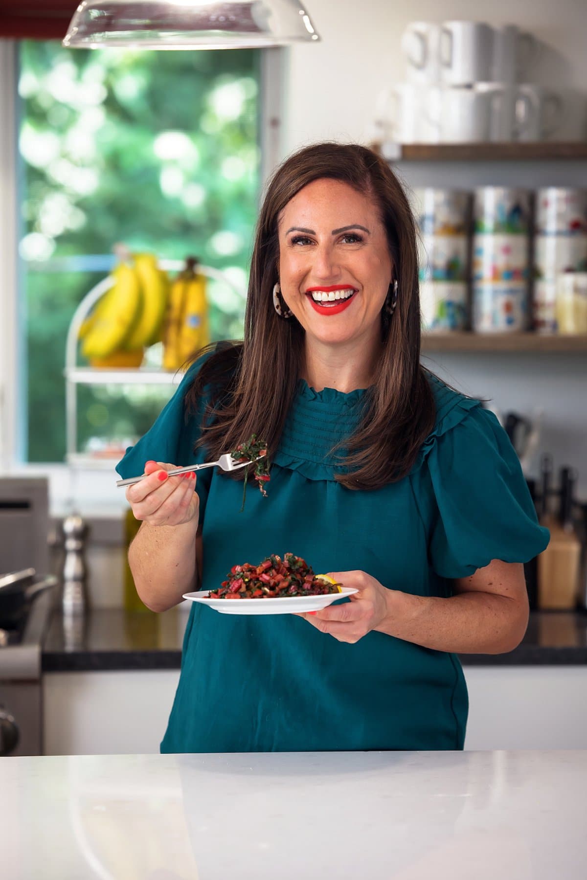 Liz enjoying a plate of sautéed swiss chard with lemon and garlic.
