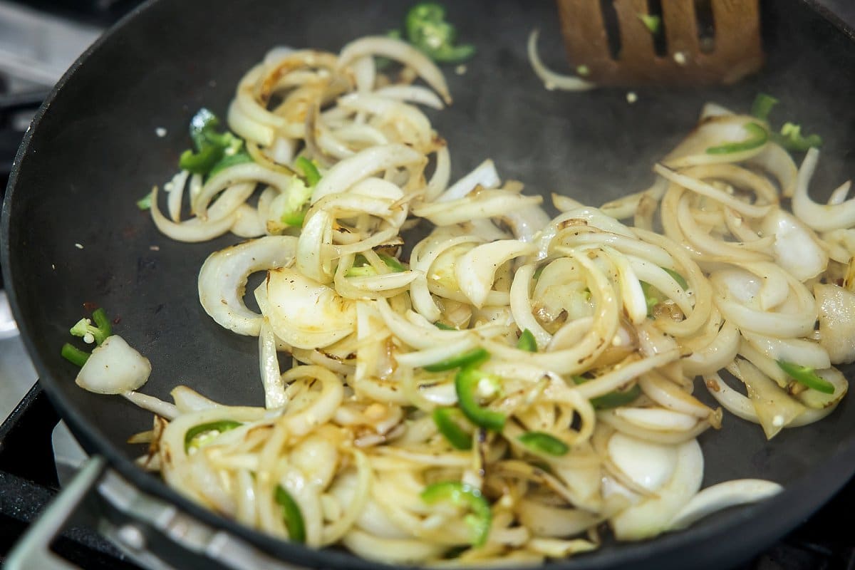 Sautéing onions with jalapeños and garlic.