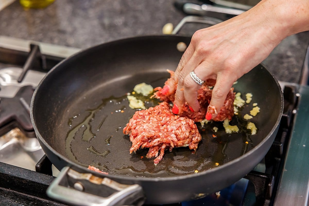 cooking sausage in pan