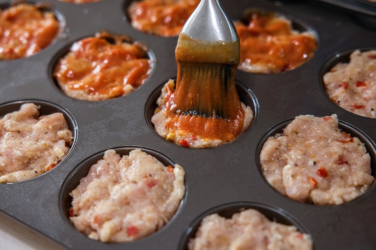 Brushing sauce on turkey muffins
