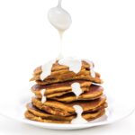 Drizzling syrup over pumpkin pancakes