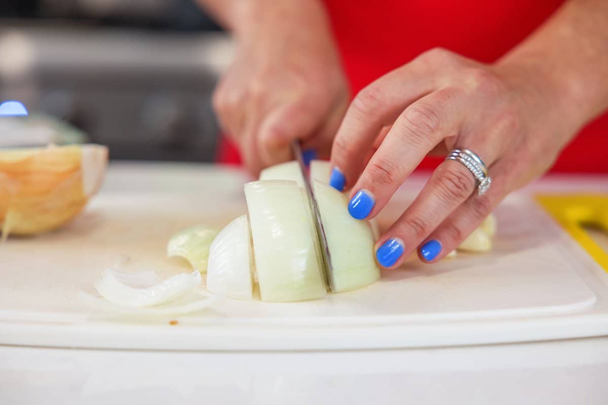 person cutting an onion
