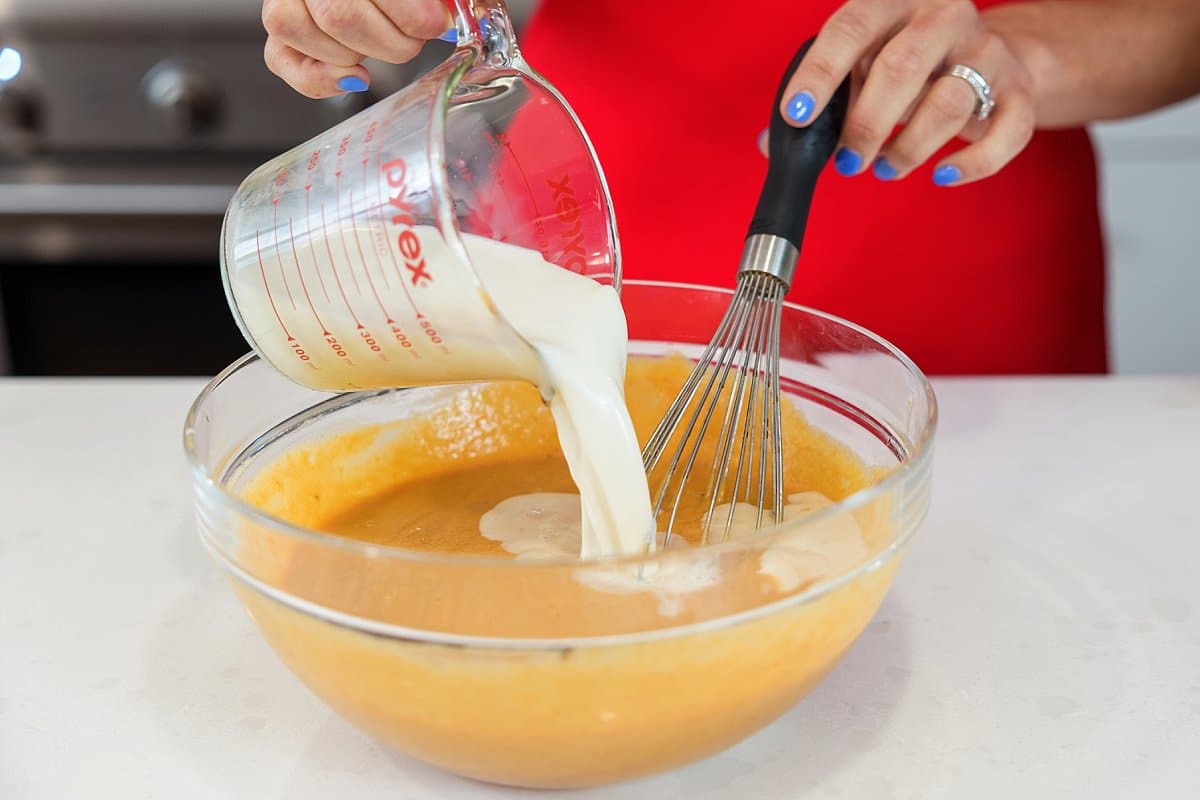 Stirring milk into pumpkin pancake mix